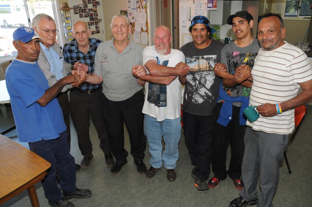 Richard Smith, Don Nolan, Phil Walker, George Akerstrom, co-ordinator of CDEP Steve Ross, Lloyd Ross, Steven Bugmy and Terry Doolan link hands and friendships at the Dubbo Men’s Shed.    Photo: LISA MINNER
