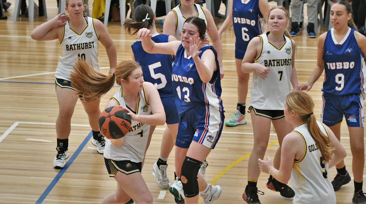 HANDS UP: Dubbo's Regan Sanderson looks to keep a Bathurst player away from the basket. Picture: CHRIS SEABROOK