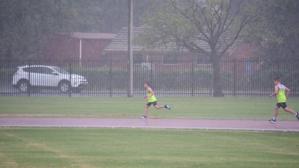 RUNNING IN THE RAIN: A competitor from the recent Little Athletics Region 3 State Qualifying Meet weren't worried about the wet weather. Photo: AMY MCINTYRE