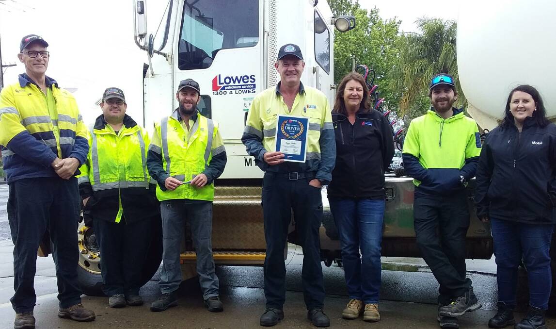 PROUD: Roger Hinton (centre) was rewarded for his committment to safety by Lowes Petroleum. Picture: CONTRIBUTED