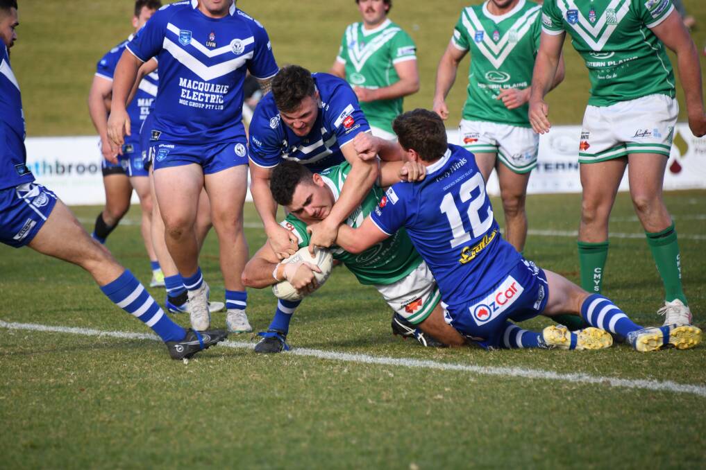 Dubbo CYMS star Alex Bonham attempts to score earlier this year against Jack Kavanagh (top tackler) and Macquarie. Picture by Amy McIntyre