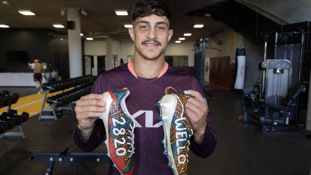 Wellington junior Kotoni Staggs with specially designed boots ahead of the NRL's Indigenous Round. Picture by Brisbane Broncos