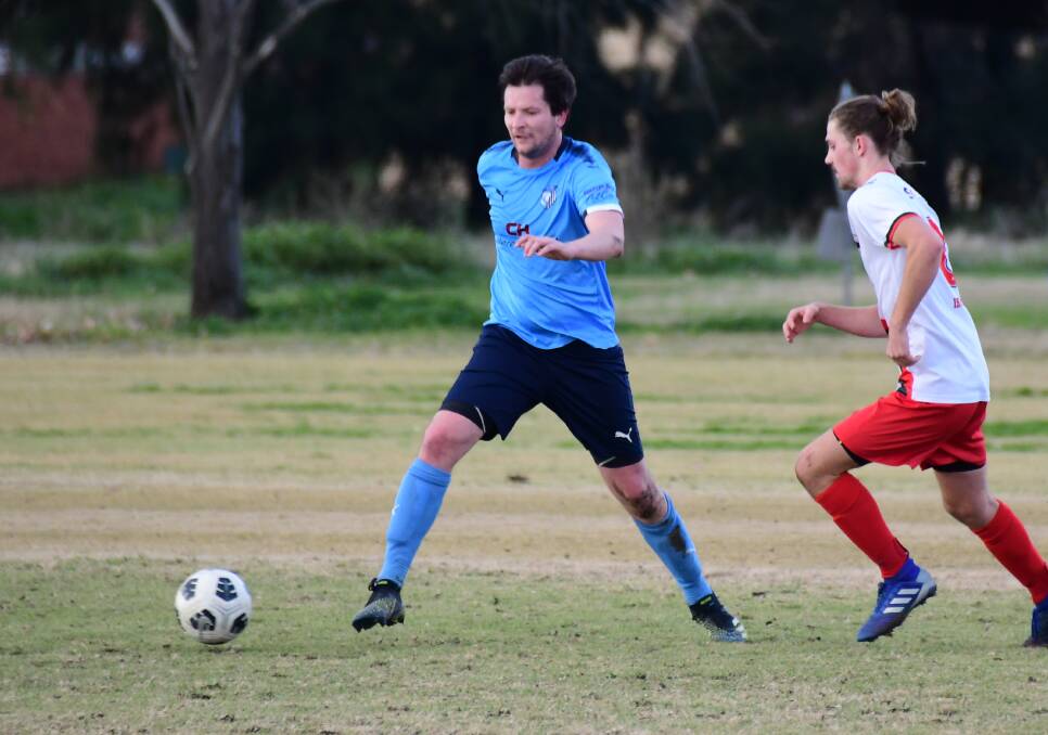 ON THE BALL: Macquarie United's Matt Hull looks to evade a defender on Sunday. Photo: AMY MCINTYRE