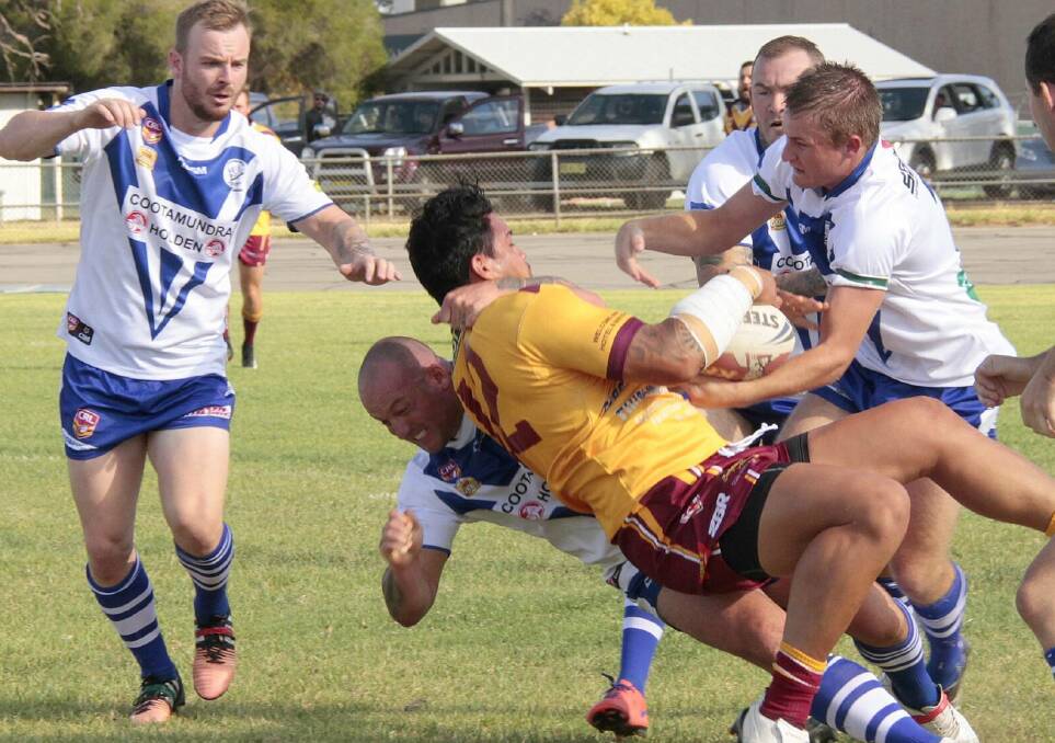 Cootamundra Bulldog's Rob Tulenew slams former NRL player Anthony Cherrington to the ground during the trial against Thirlmere on Saturday. Picture by Kelly Manwaring