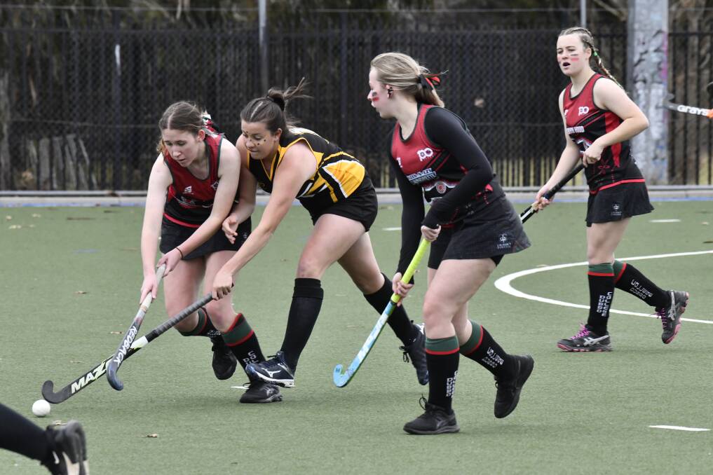 Orange battle to retain the ball in their clash with Dubbo at Orange Hockey Centre. Picture by Carla Freedman