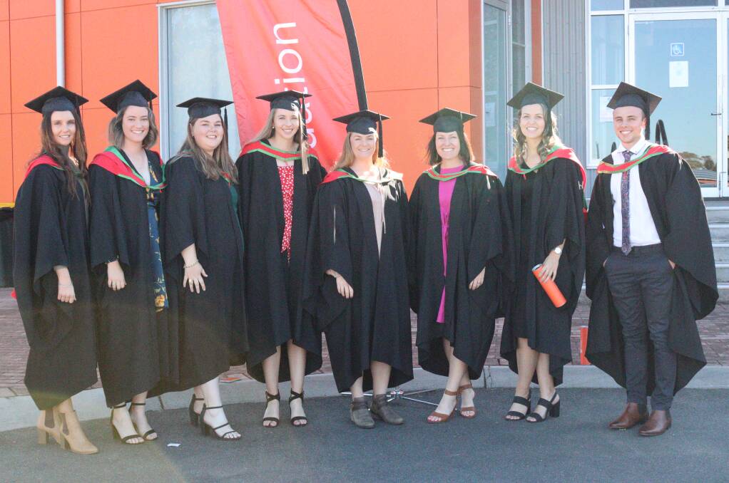 NEXT CHAPTER: Charles Sturt University students celebrating their 2020 graduations at the Bathurst campus on Wednesday. Photo: AMY REES