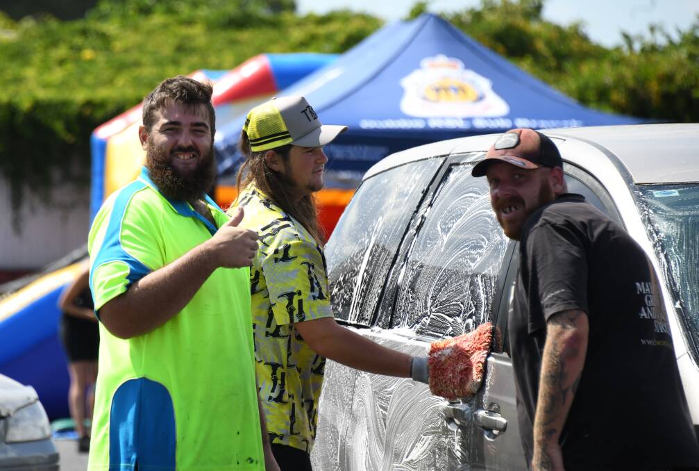 Jay Walsh and other volunteers clean a car at the Men's Mental Health Charity Car Wash. Picture by Belinda Soole