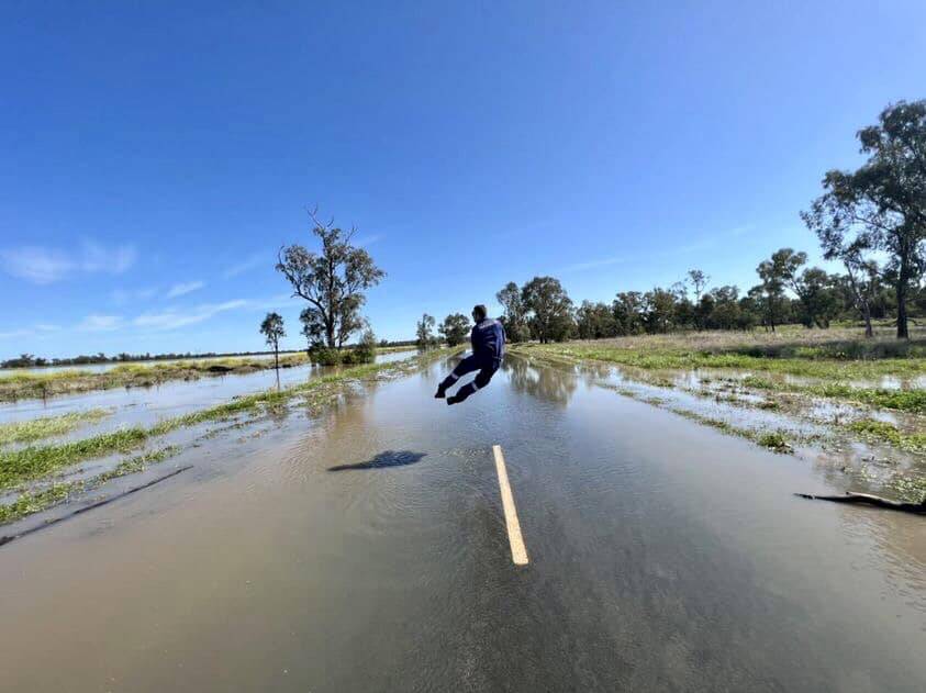 NSW Ambulance paramedic James on a flooded road in Warren earlier this week. Picture via Facebook/NSW Ambulance