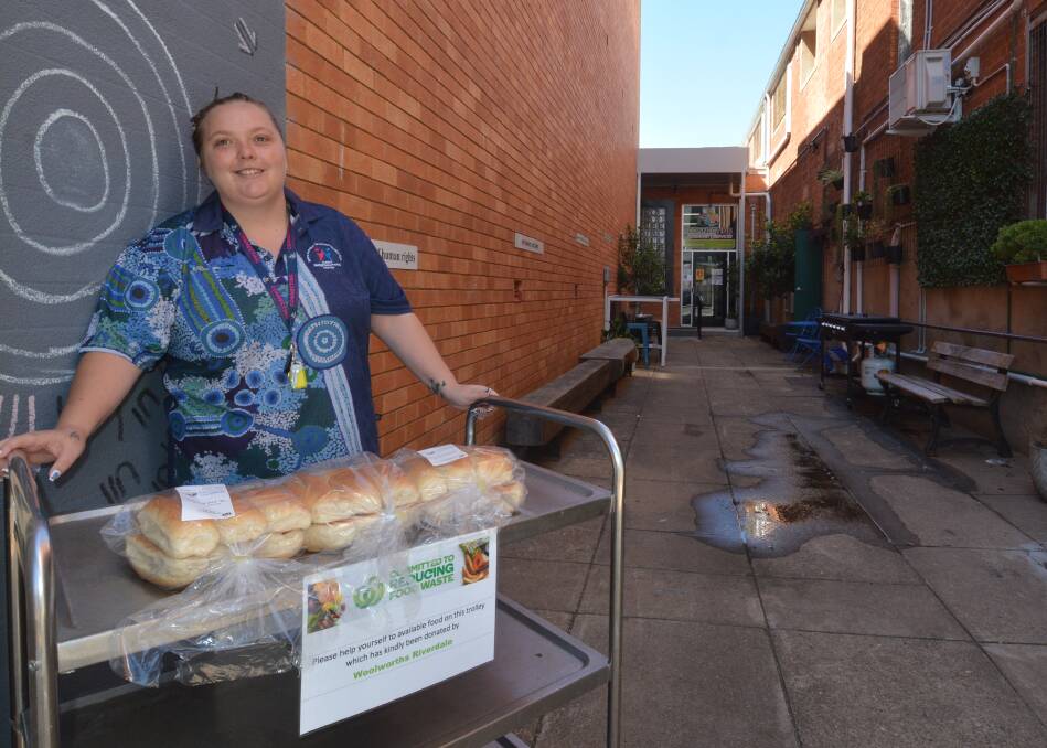 Rachael Bailey with the free food cart in the laneway of the Connecting Community Services. Picture by Elizabeth Frias