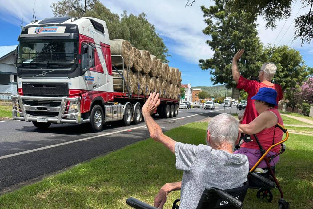 An Aussie Hay Runners truck is greeted by members of the community on one of their hay runs. Picture via Facebook/Aussie Hay Runners
