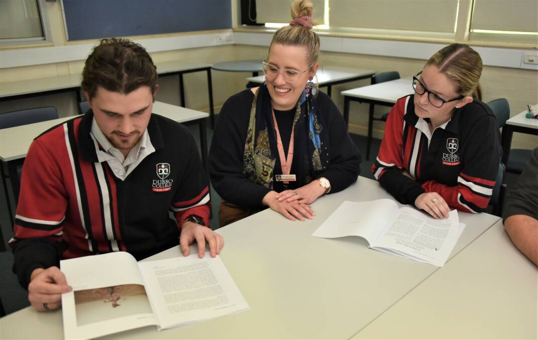 Dubbo College students Hugh Olney and Ashely Steele review the exam with English teacher Rebecca Brown. Picture supplied