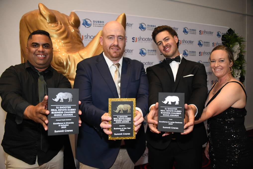 Austin Sullivan, Joshua Shields and Tyler Melville show off Summit Cranes' haul from the 2023 Dubbo Business Chamber awards night. Picture by Amy McIntyre
