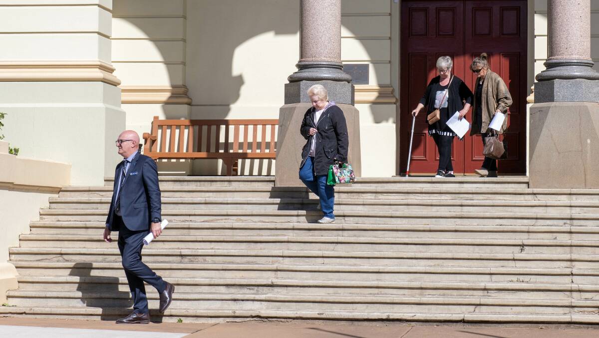 Detective Adrian Tighe (left) and Robert Dickie's friends and family members enter Dubbo Court for the final day of the trial. Picture by Belinda Soole