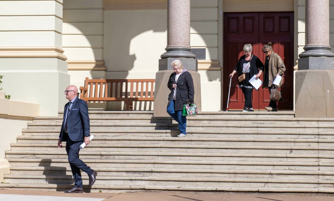 Detective Adrian Tighe (left) and Robert Dickie's friends and family members enter Dubbo Court for the final day of the trial. Picture by Belinda Soole