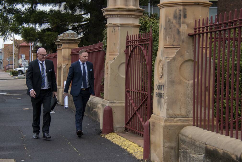  Detective sergeant Adrian Tighe (left) enters Dubbo Court for the first day of Kylie So's trial for Robert Dickie's murder. Picture by Belinda Soole