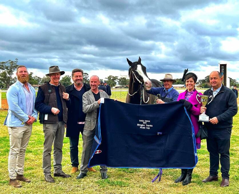 'FAMILIAR TERRITORY': Lawrence Mooney (third from the left) at the Duck Creek Picnic Races where he saw the retired race horse he bought run. Picture: Facebook/Duck Creek Picnic Races