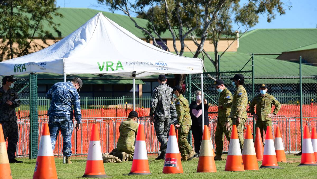WALK-IN VACCINATIONS: ADF personnel setting up at Pioneer Park for a mass vaccination clinic to run from Saturday. Photo: AMY MCINTYRE 