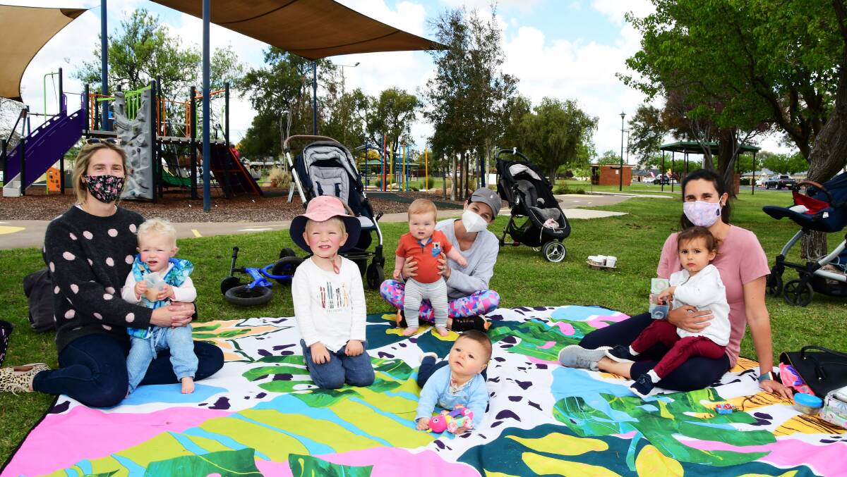 PARK DAY: From left, Liz Whiteley holding one-year-old daughter Alice with son Hugh, Majella Kinscher and eight-month-old Teddy, and Natasha Young and two-year-old Maisie, with baby Louis in the centre, enjoying Wahroonga Park on Monday. Photo: BELINDA SOOLE