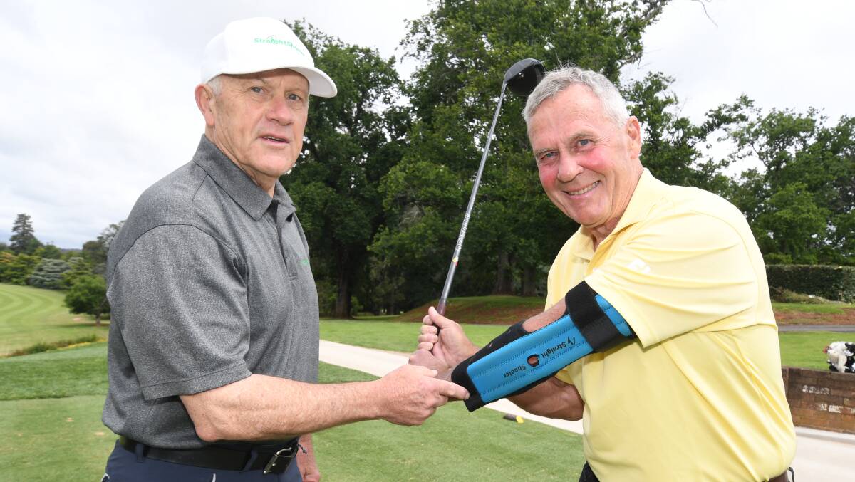 CHIPPING AWAY AT HIS HANDICAP: StraightShooter inventor Mike Middleton with golfing buddy Dave Currall. Photo JUDE KEOGH