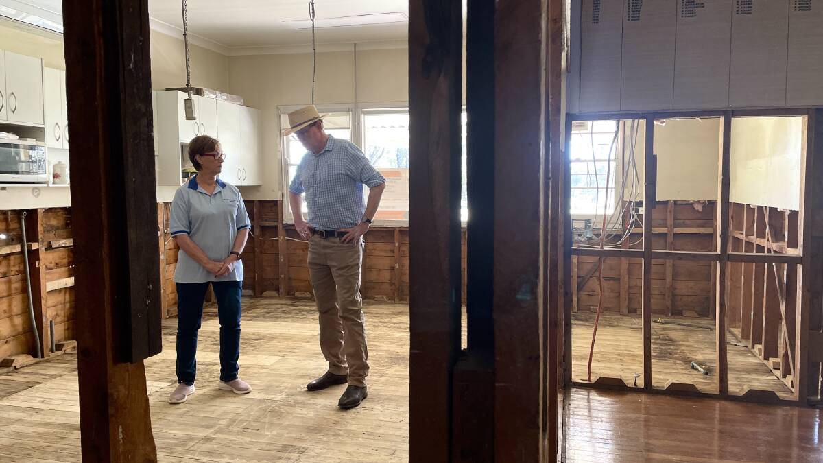 Treasurer for Molong Bowling Club, Yvonne Clyde in the club's deluged kitchen with member for Calare, Andrew Gee on Tuesday. Picture by Emily Gobourg.