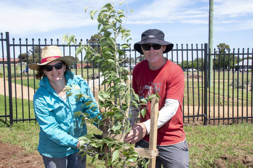 Fiona and Geoff Gibbons are among the busy bees who sow flowering shrubs at Macquarie Home stay's garden for patients at Dubbo Hospital. Picture by Belinda Soole