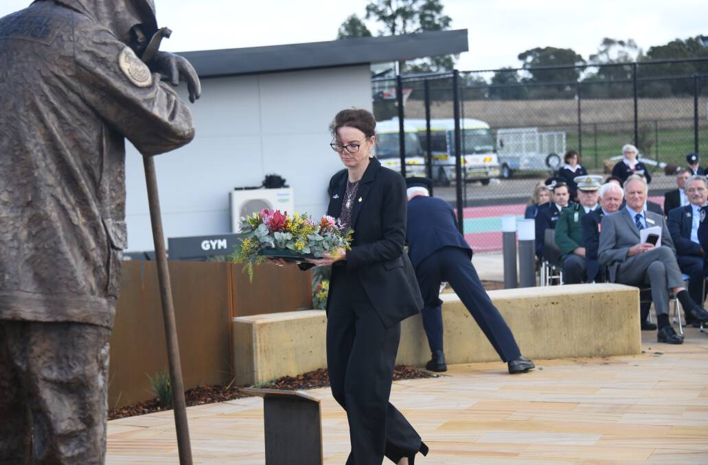 Emergency services and resilience minister Steph Cooke lays a wreath at the RFS Memorial Garden to honour the 95 firefighters killed in the line of duty since 1932, including 26 since 2011. Picture: Amy McIntyre