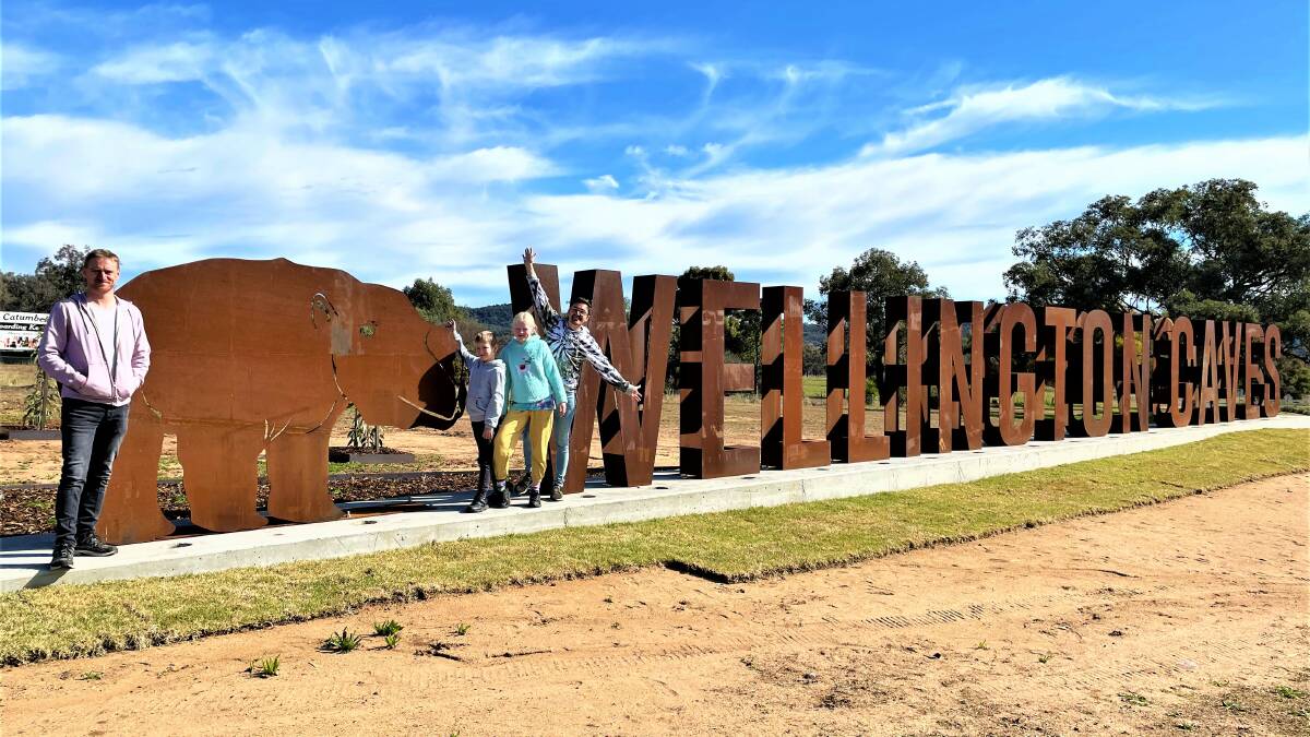 The recently added attraction to Dubbo is the big sign at Wellington Caves as this family from Sydney has discovered on their trip last week. Picture: Elizabeth Frias 