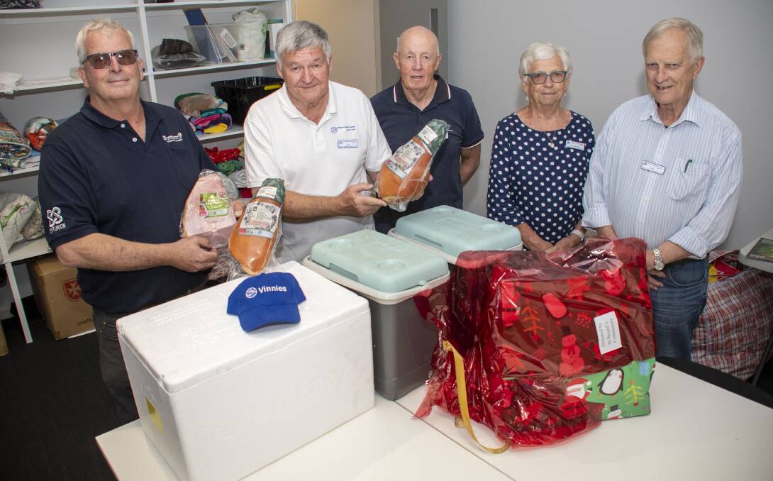 Christmas hampers that went to families experiencing difficulties this year with Jim Montague from Mining Camps Australia, St Vinnies' Ian Wray, Peter Hargreaves, Barbara Kelly and Pat Yeo. Picture by Belinda Soole