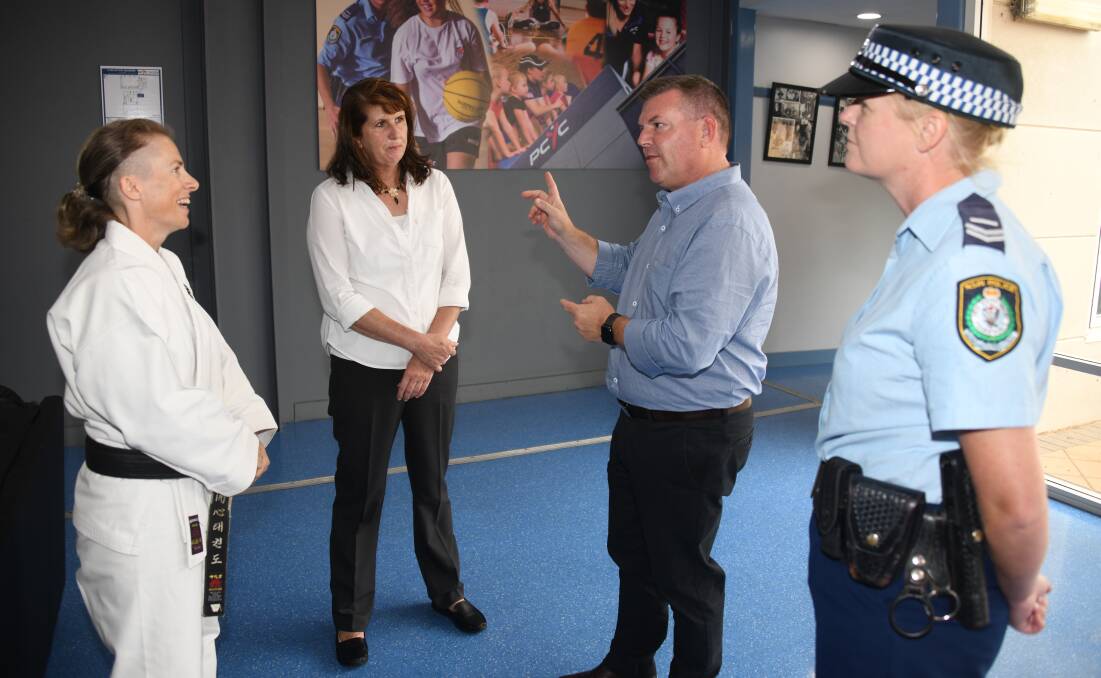 Kaishin Taekwondo instructor Kym Housden discussing how she teaches self-defense with Angela Coker of Dubbo Violence Prevention Collective, Dubbo MP Dugald Saunders and Detective Sergeant Sally Treacey of Dubbo Police Youth and Crime Prevention Command at PCYC.