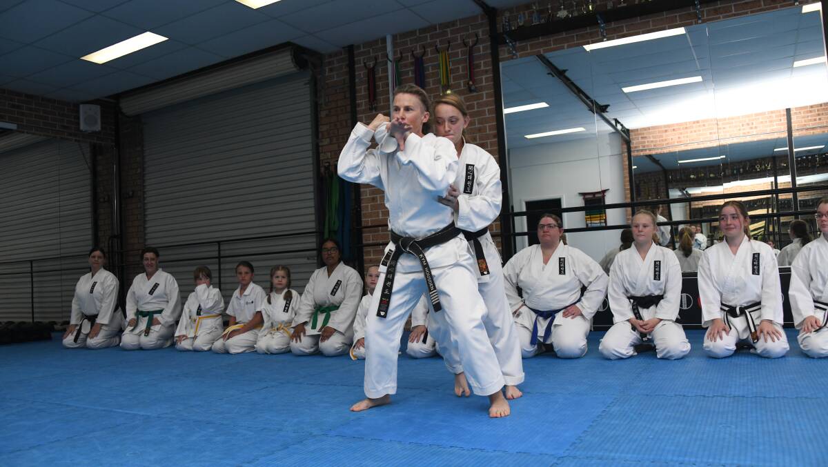 A self-defense technique taught by Kaisin Tekwondo instructor Kym Housden in a sparring match with Beatrice Reynolds Lamont. PHOTO: AMY MCINTYRE