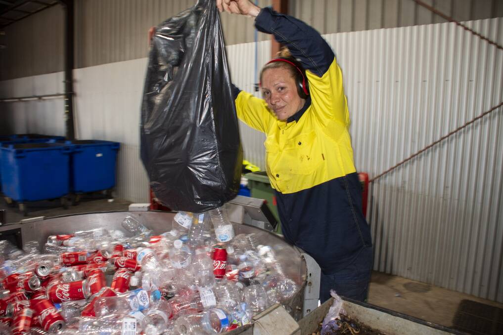 St Vinnies' return and earn depot supervisor Susana Ramirez processing last Monday's collection of recyclable containers from Dubbo's households. Picture by Belinda Soole