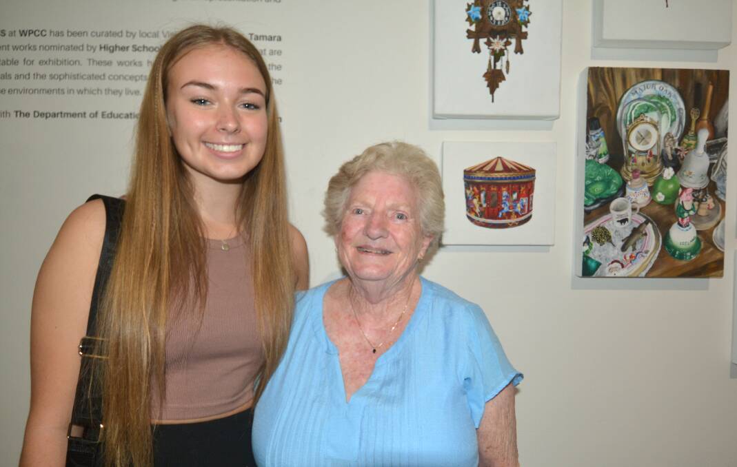 St John's College student Keira Bussey with her grandmother Judith Wonderley at the opening of the Art Express exhibition at Western Plains Cultural Centre on Friday, 24 February 2023. Next to them is her winning painting, Back to Grandma. Picture by Elizabeth Frias
