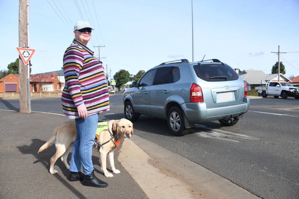 Annette Ferguson and her guide dog Leo, wait to cross the Wingewarra Street/Fitzroy Street roundabout near Dubbo showground. Picture: Amy McIntyre