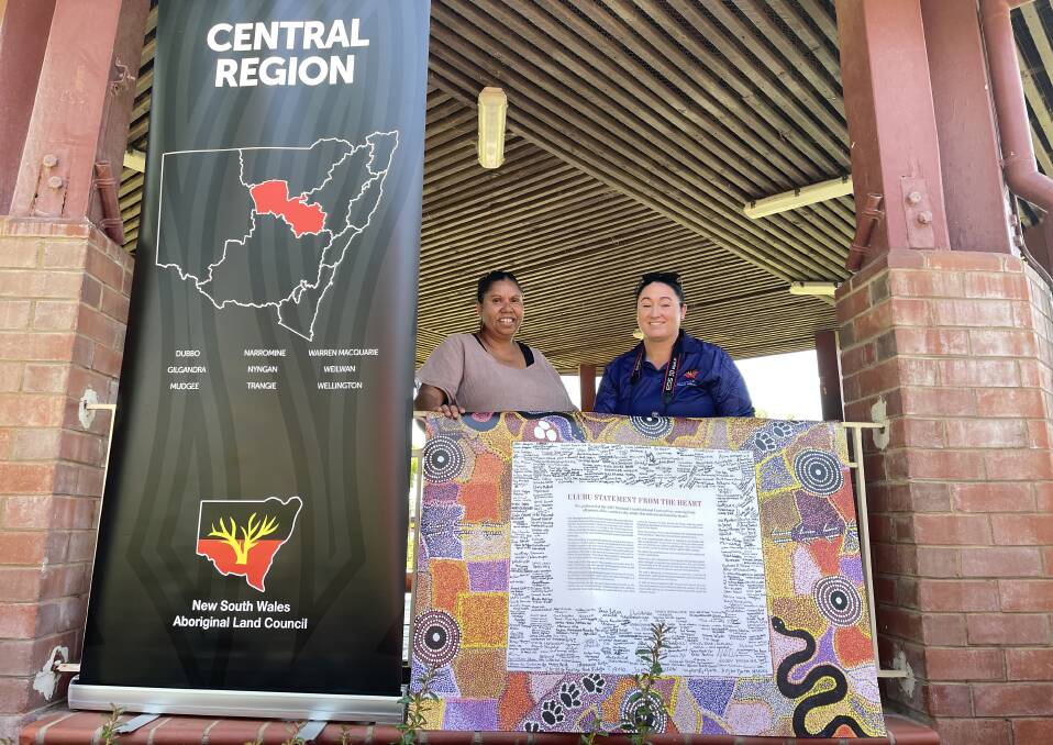 Grace Toomey and Louise Austin from the NSW Aboriginal Land Council put up the Uluru Statement in preparation for the event. Picture by Bageshri Savyasachi