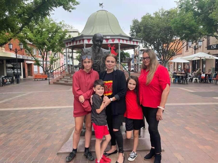 Tatum Moore, centre, with her three children and her mother, Jenis Ferguson, stand with the statue of her great-great grandfather, William Ferguson, in Dubbo's Rotunda. Picture: Supplied
