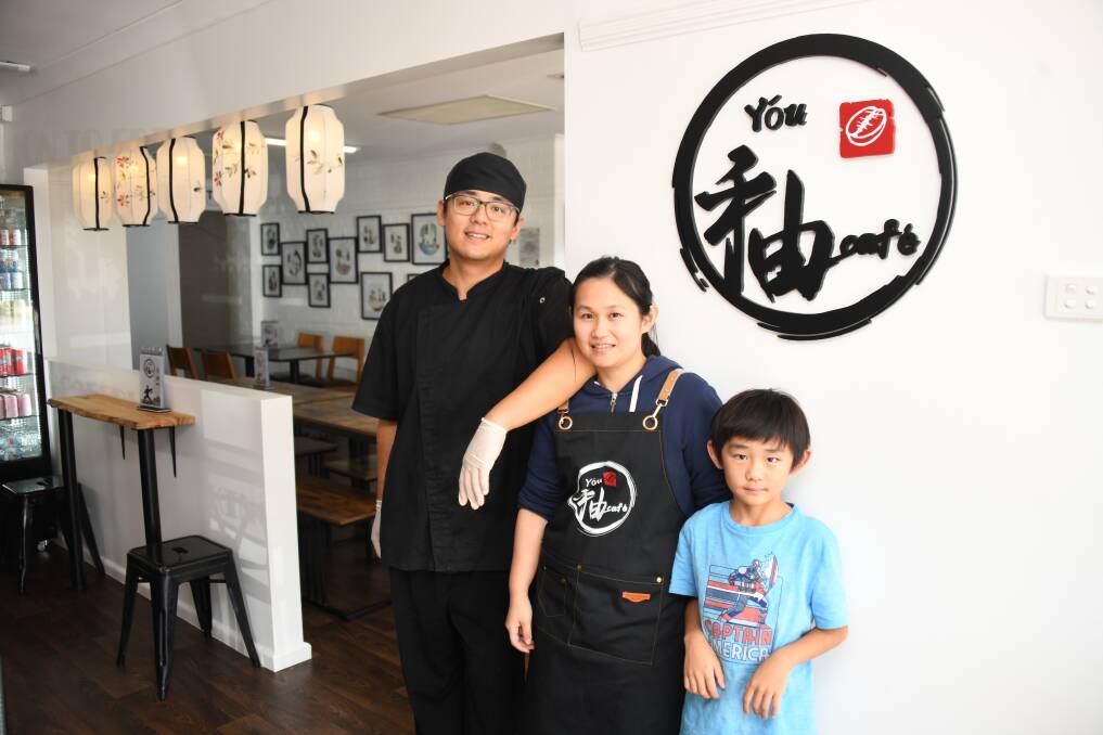 Chef David Shi and Belle Wong with their son, You, pictured inside their family café. Picture by Amy McIntyre