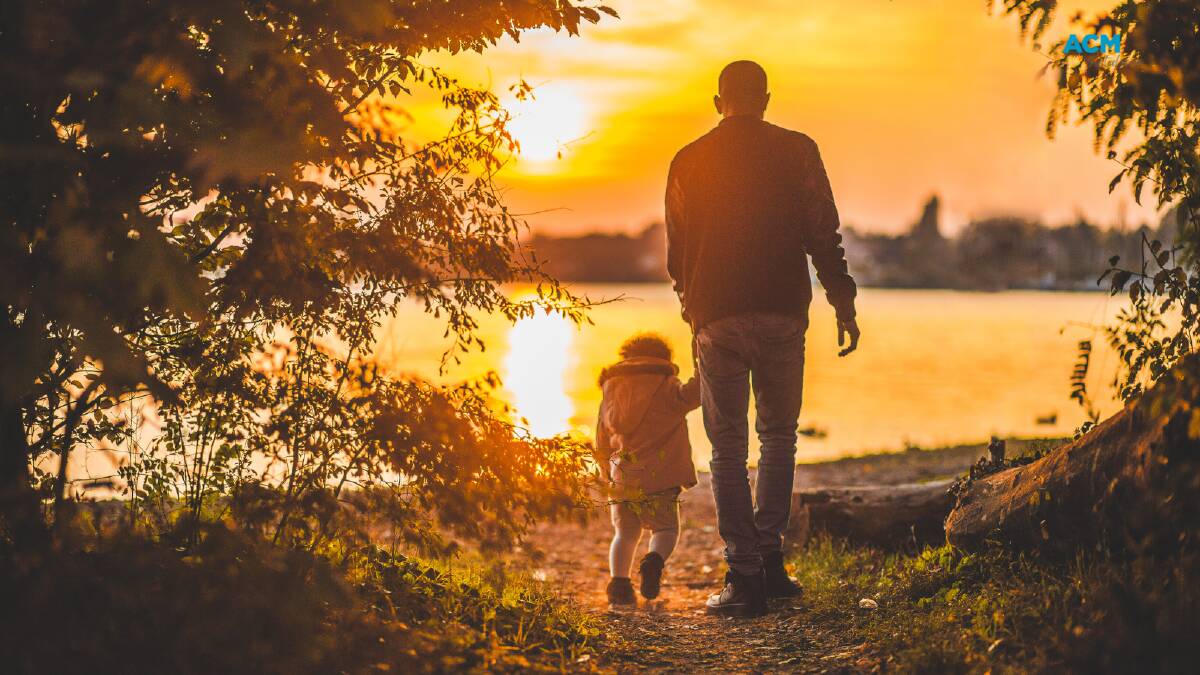 Father and daughter on a sunset walk. Picture via Canva