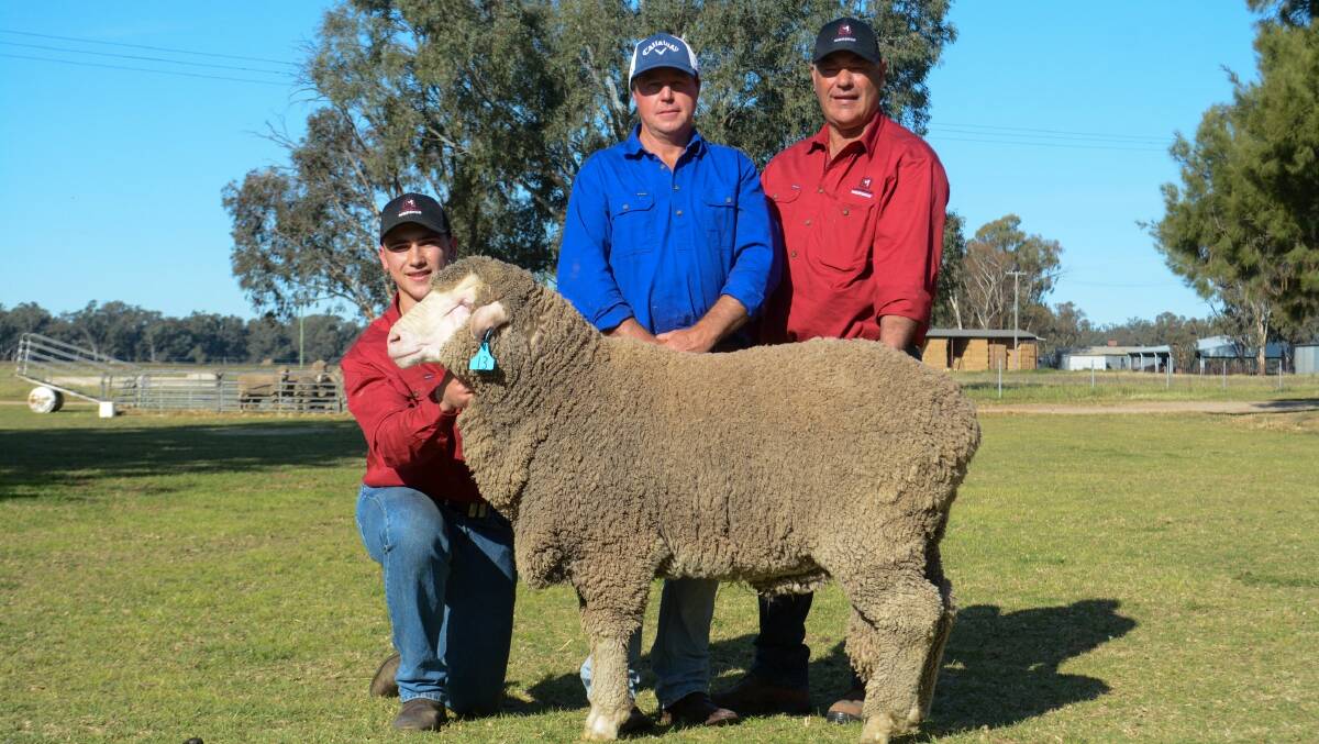 Campbell Rubie, Lachlan Merinos, buyer Scott Gibson, Bald Ridge, and Glen Rubie, Lachlan Merinos, with one of the top-priced rams, which sold for $8500. Picture by Elka Devney