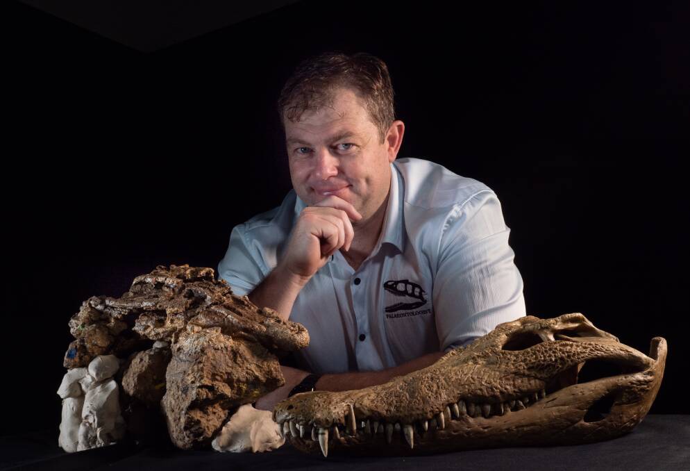 DISCOVERY: A team led by UNE postdoctoral researcher Dr Matt White, pictured, found the remains of a juvenile dinosaur in the crocodile's gut region.