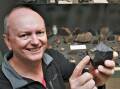 ORIGIN OF LIFE: Bathurst Observatory owner Ray Pickard with a meteorite fragment from his collection. Photo: CHRIS SABROOK 050122cmeteor1a
