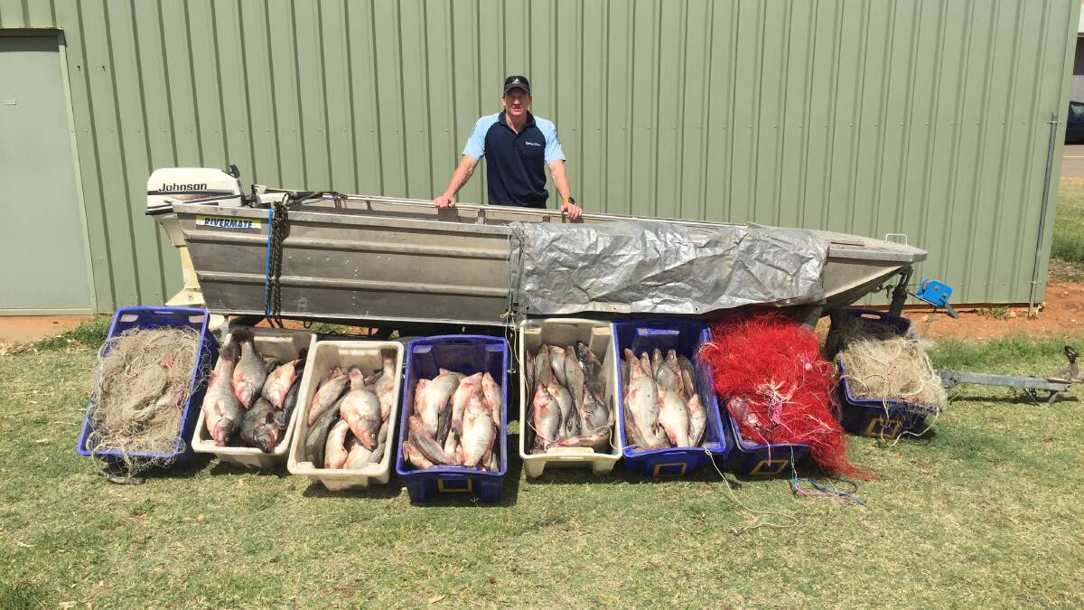Caught: NSW DPI Fisheries officer Peter Heath with seized items. Photo: NSW DPI Fisheries.
