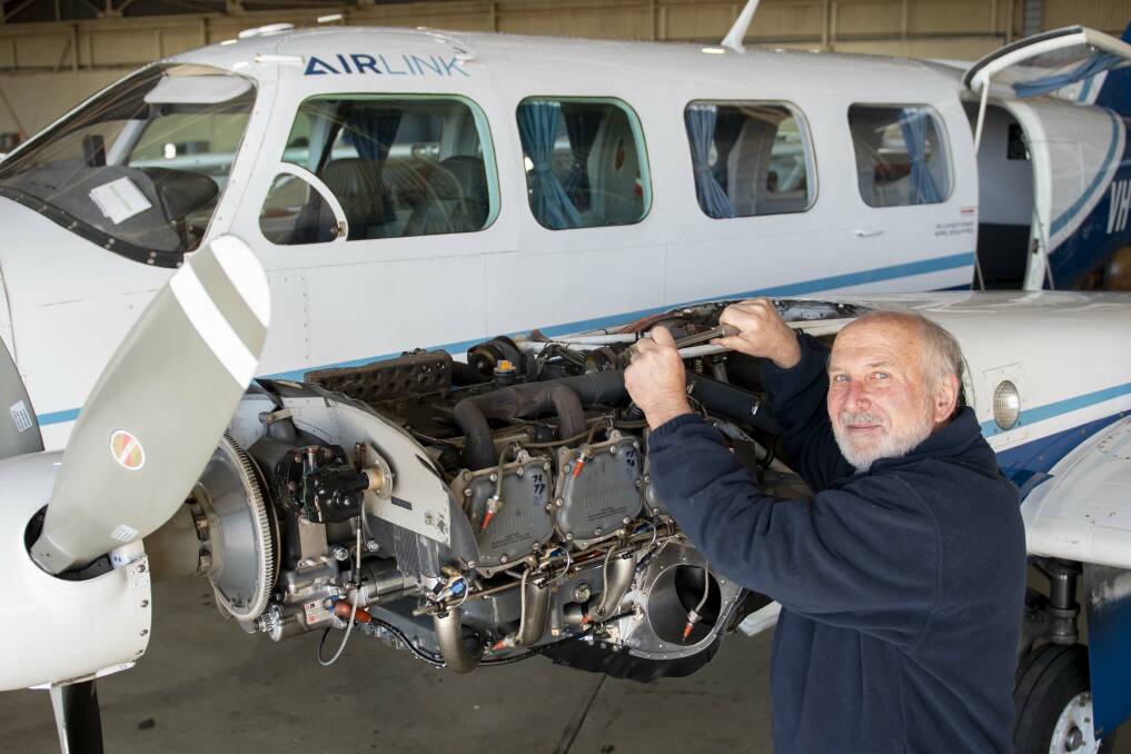 John Greenhill working on the engine of an Airlink aircraft. Picture: Belinda Soole 