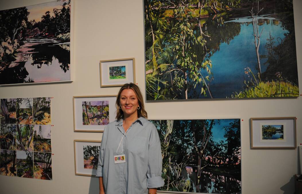 Dubbo artist Catherine Jones standing in front of some of her works at Dubbo Art Fair. Picture by Ciara Bastow 
