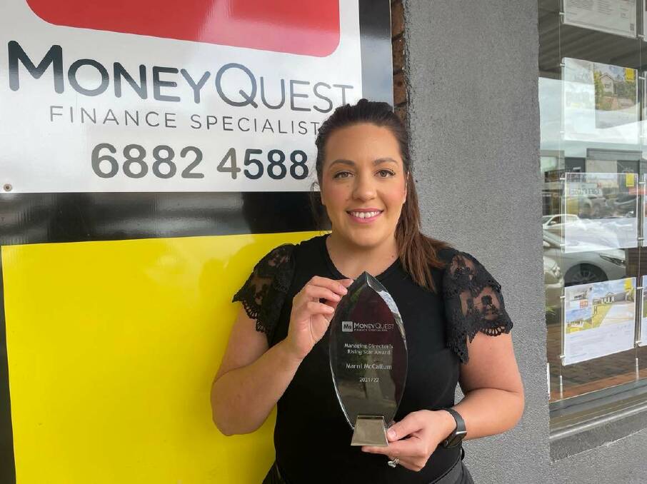 Finance specialist Marni McCallum with her 'Rising Star' award out the front of Dubbo's MoneyQuest office. Picture by Ciara Bastow 