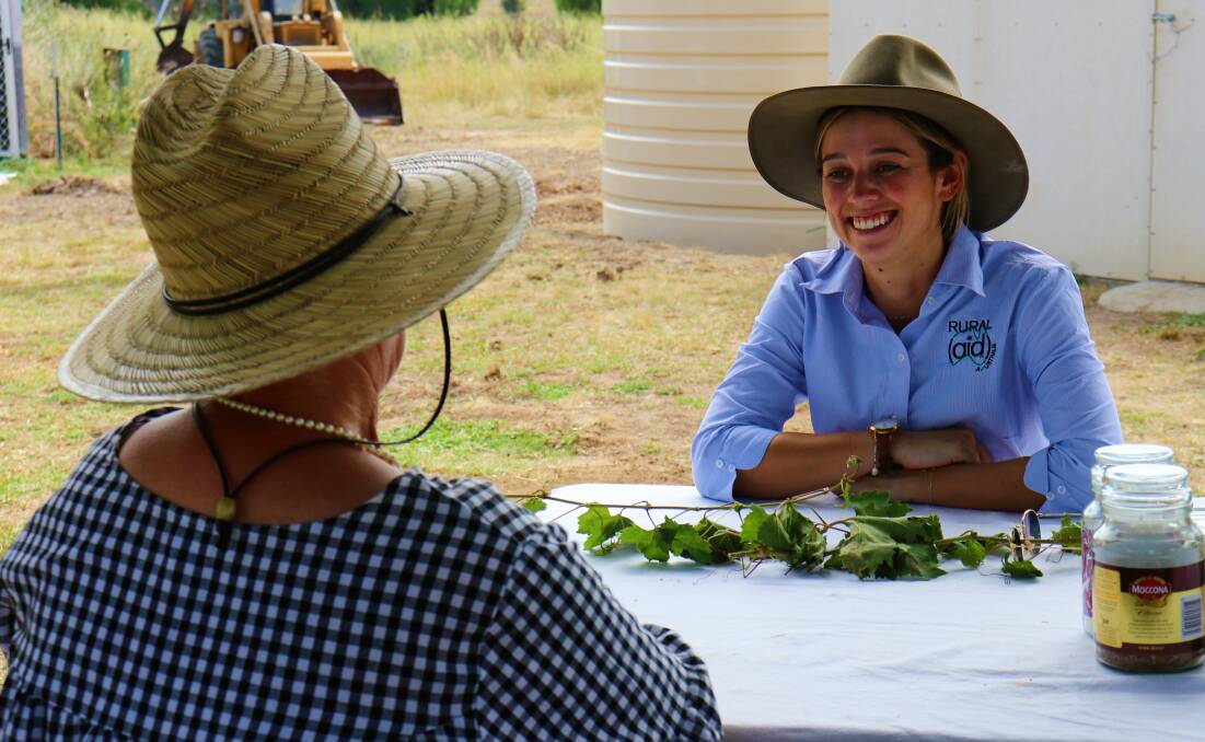 Rural Aid counsellor Heidi Gray speaks with a farmer. Picture supplied. 