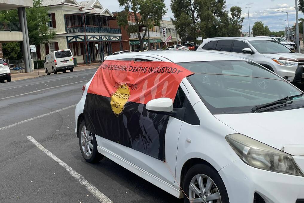 A car with a banner on the side that says 'Stop Aboriginal deaths in custody'. Picture by Ciara Bastow 