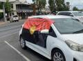 A car with a banner on the side that says 'Stop Aboriginal deaths in custody'. Picture by Ciara Bastow 