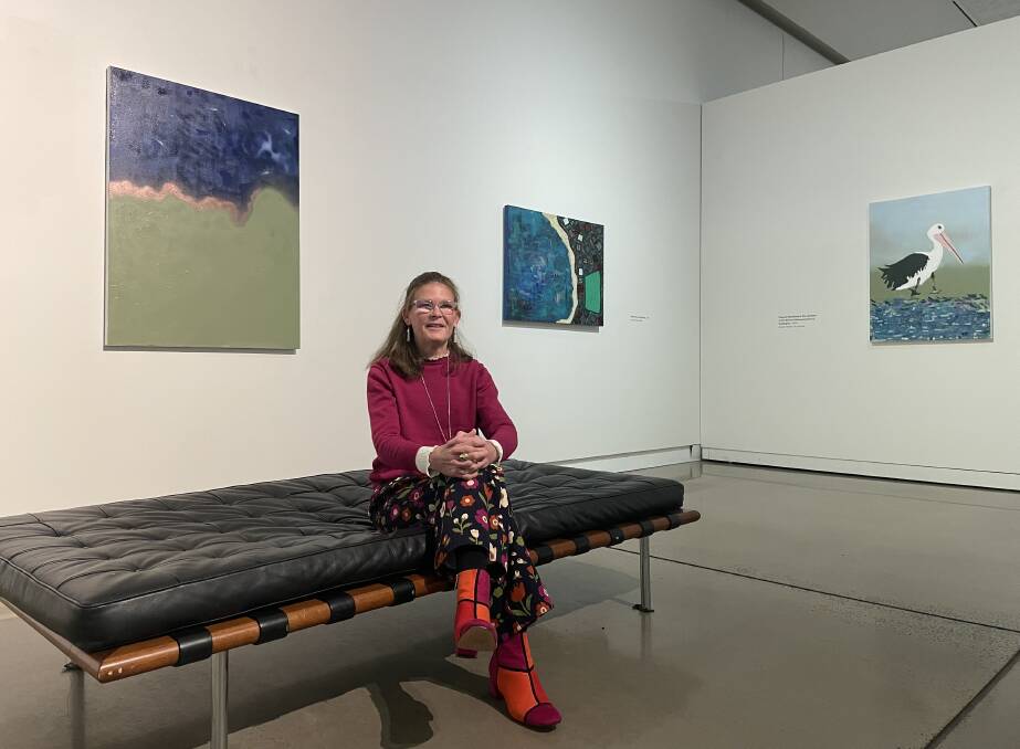 Artist Kate Kenworthy sat in front of three of her water-related art works in an exhibition on show at the Western Plains Cultural Centre. Picture by Ciara Bastow 