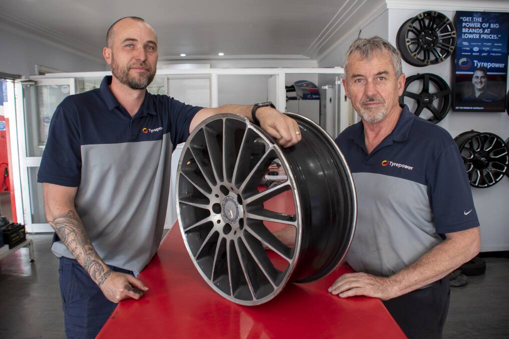 Marty and Max Robertson with just one of the damaged tyres they have in store. Picture by Belinda Soole 