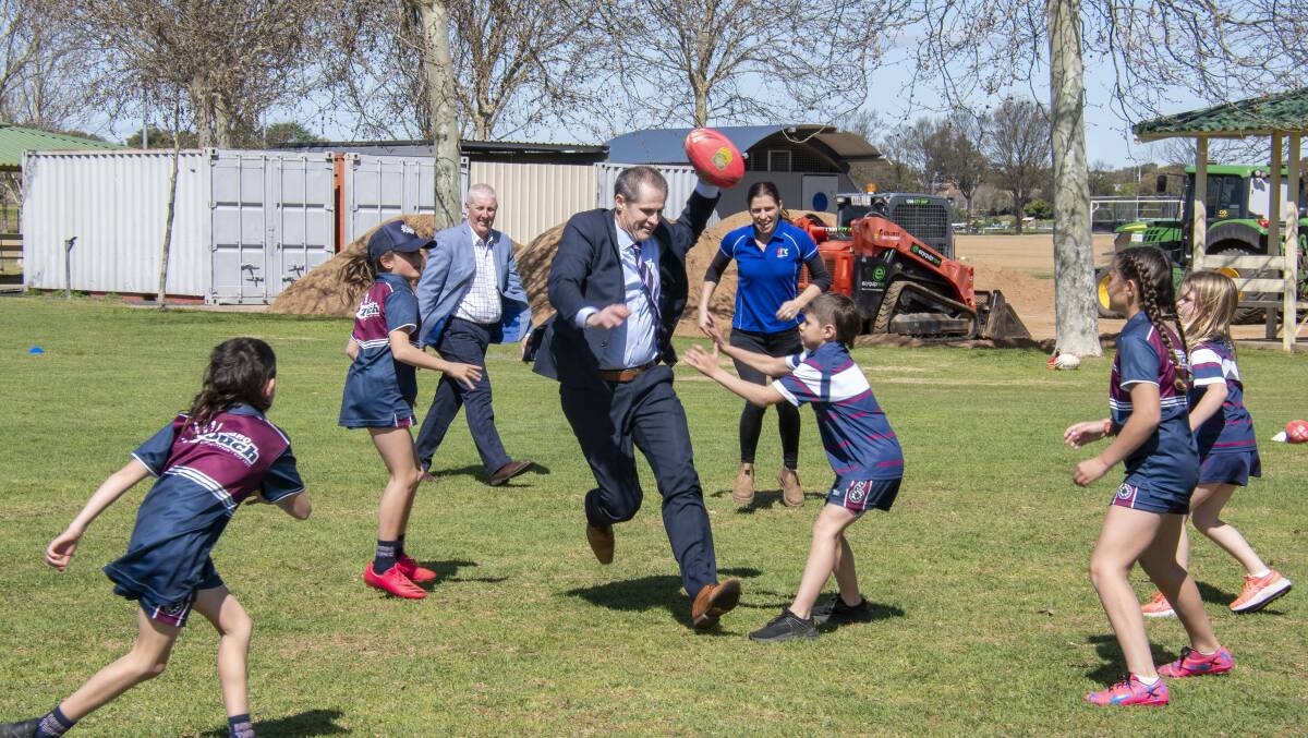 Dubbo mayor Mathew Dickerson plays a small game of touch football with some kids. Picture by Belinda Soole 
